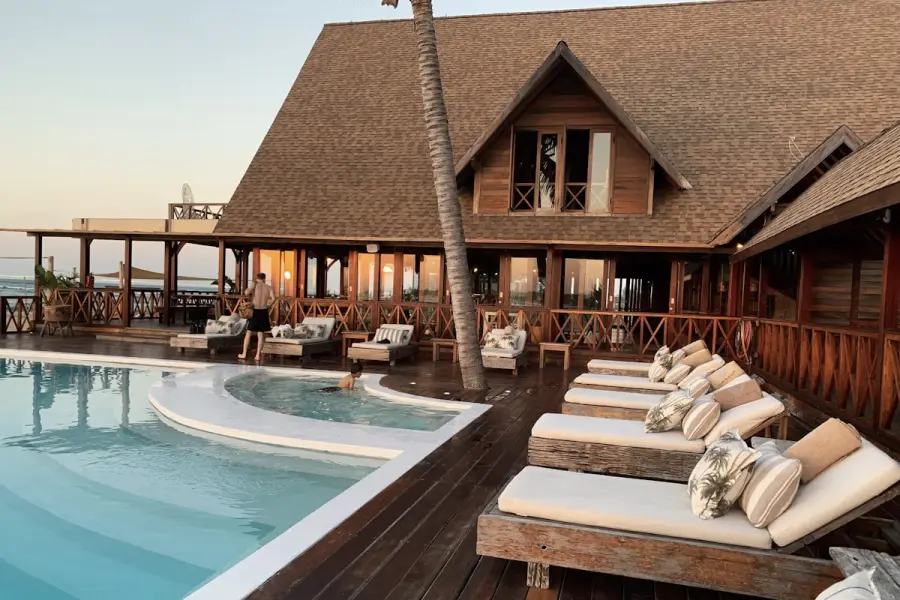 Beachside resort terrace with a pool and sun loungers